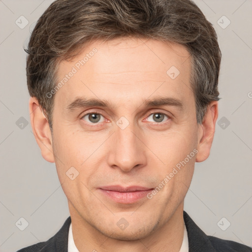 Joyful white adult male with short  brown hair and grey eyes