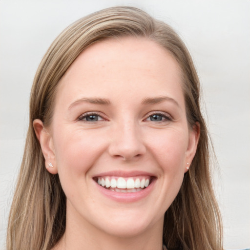 Joyful white young-adult female with long  brown hair and blue eyes