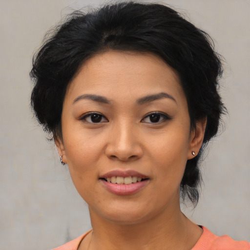 Joyful asian young-adult female with medium  black hair and brown eyes