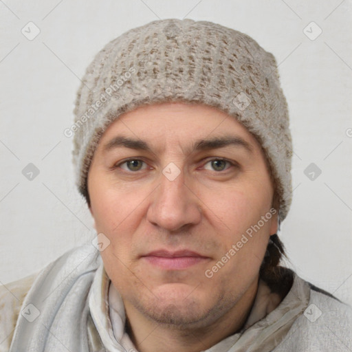 Joyful white adult male with short  black hair and brown eyes