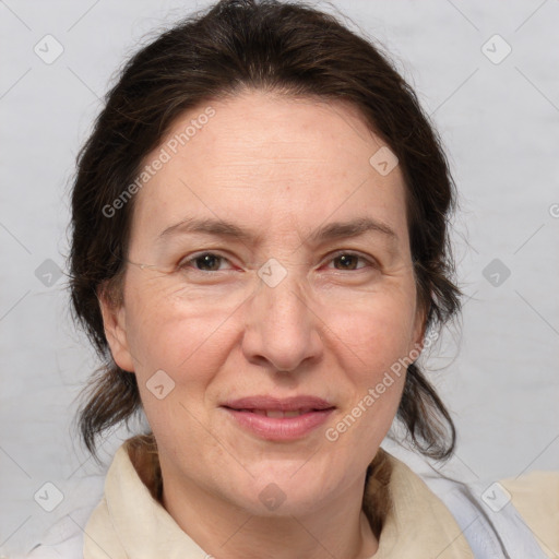 Joyful white adult female with medium  brown hair and brown eyes