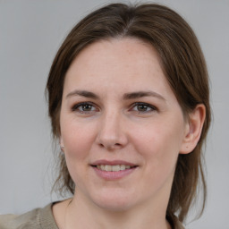 Joyful white young-adult female with medium  brown hair and grey eyes