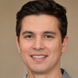 Joyful white young-adult male with short  brown hair and brown eyes