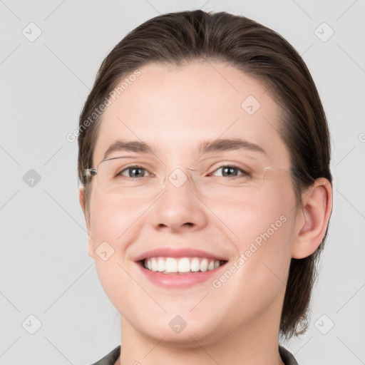 Joyful white young-adult female with medium  brown hair and grey eyes