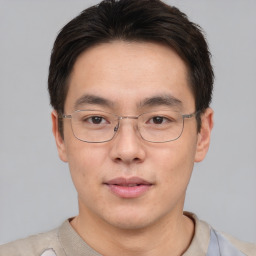 Neutral asian young-adult male with short  brown hair and brown eyes