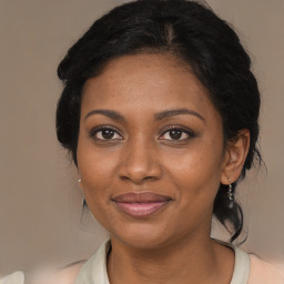 Joyful black adult female with medium  brown hair and brown eyes