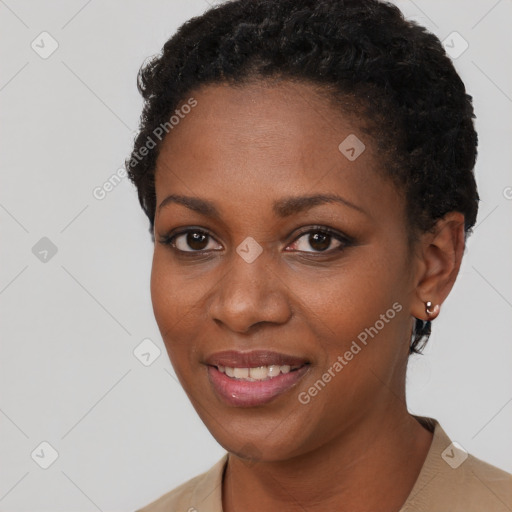 Joyful black young-adult female with short  black hair and brown eyes