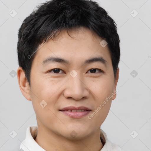 Joyful asian young-adult male with short  black hair and brown eyes