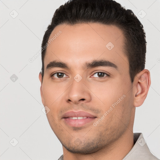 Joyful white young-adult male with short  black hair and brown eyes