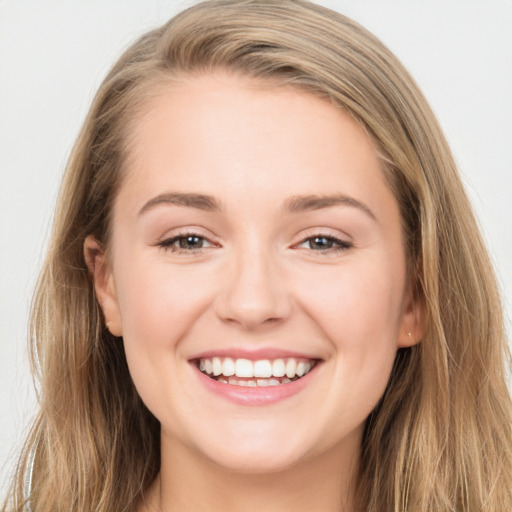 Joyful white young-adult female with long  brown hair and grey eyes