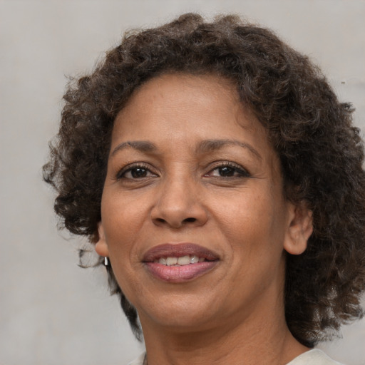 Joyful black adult female with medium  brown hair and brown eyes
