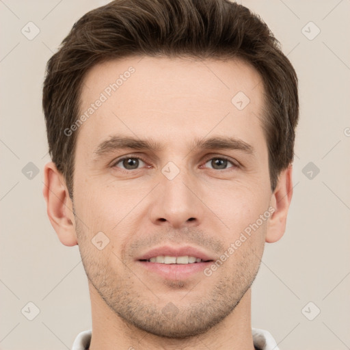 Joyful white young-adult male with short  brown hair and grey eyes