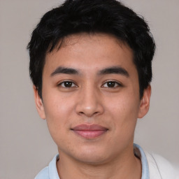 Joyful asian young-adult male with short  black hair and brown eyes