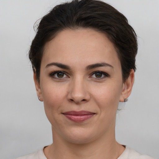 Joyful white young-adult female with short  brown hair and grey eyes
