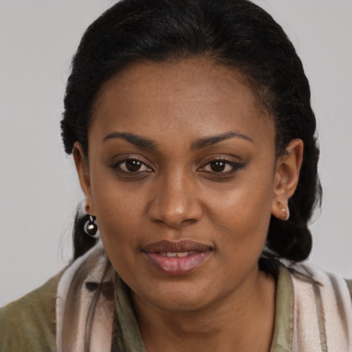 Joyful black adult female with long  brown hair and brown eyes
