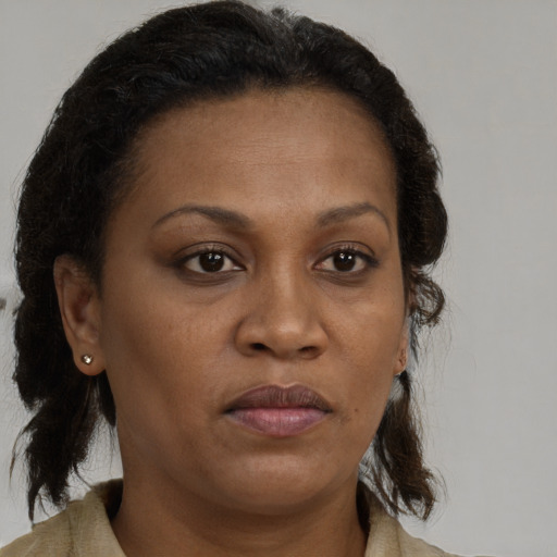 Neutral black young-adult female with medium  brown hair and brown eyes