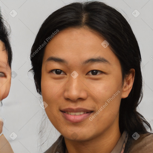 Joyful asian adult female with medium  brown hair and brown eyes