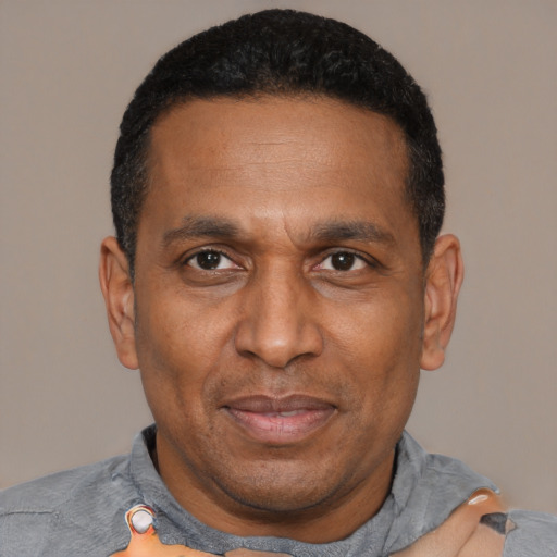 Joyful latino adult male with short  black hair and brown eyes