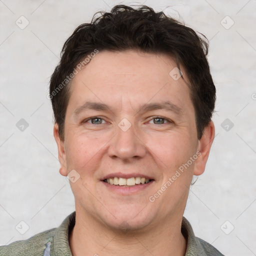 Joyful white adult male with short  brown hair and brown eyes