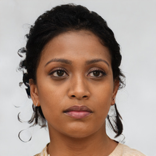 Neutral black young-adult female with medium  brown hair and brown eyes