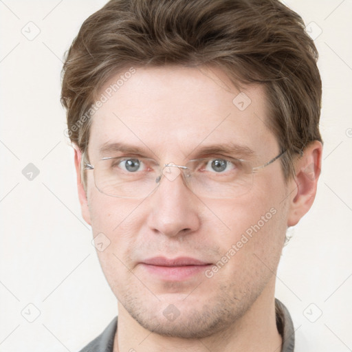 Joyful white adult male with short  brown hair and grey eyes