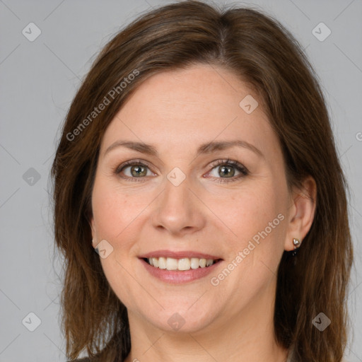 Joyful white adult female with long  brown hair and green eyes