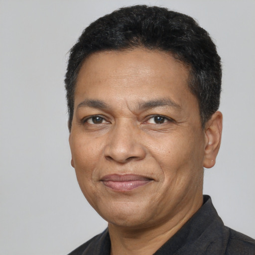Joyful latino adult male with short  black hair and brown eyes