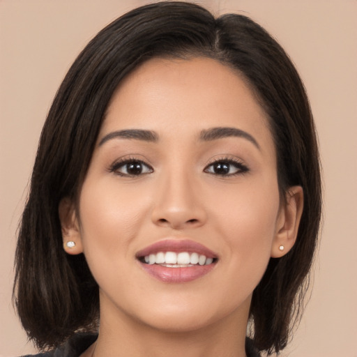 Joyful white young-adult female with long  brown hair and brown eyes