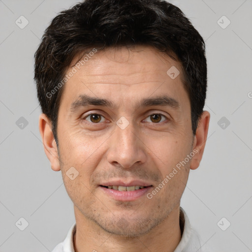 Joyful white adult male with short  brown hair and brown eyes