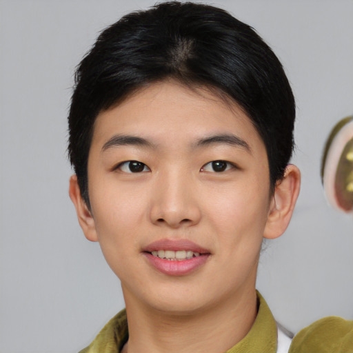 Joyful asian young-adult female with short  brown hair and brown eyes
