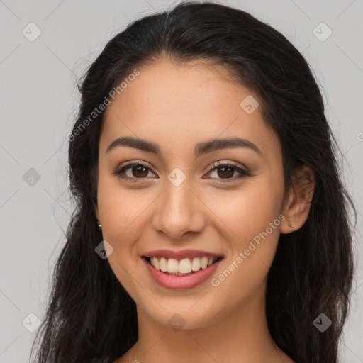 Joyful latino young-adult female with long  brown hair and brown eyes