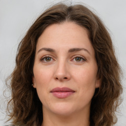 Joyful white young-adult female with medium  brown hair and green eyes