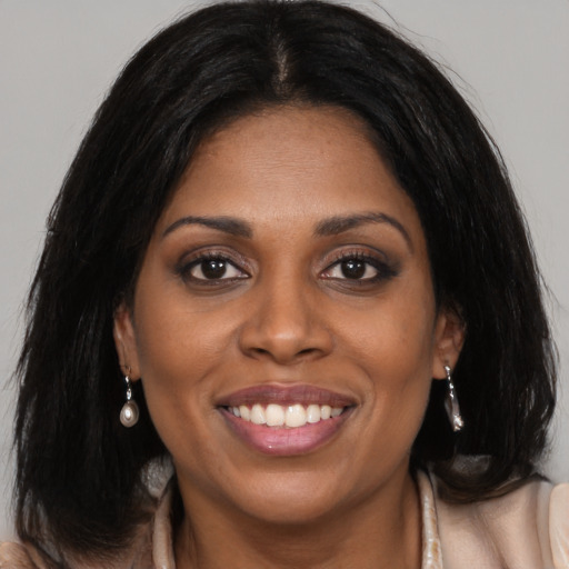Joyful latino young-adult female with long  brown hair and brown eyes
