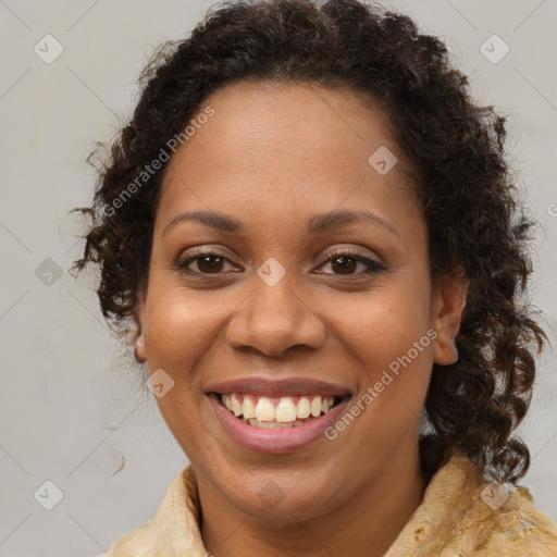 Joyful black adult female with medium  brown hair and brown eyes