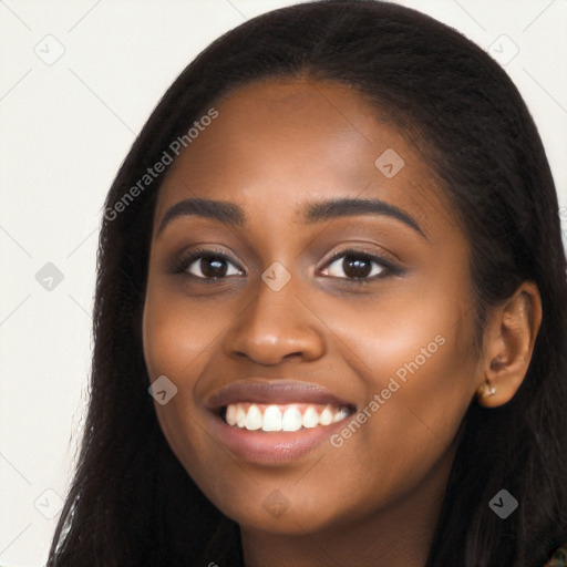 Joyful black young-adult female with long  black hair and brown eyes