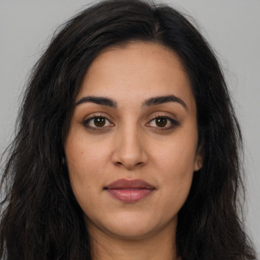 Joyful latino young-adult female with long  brown hair and brown eyes