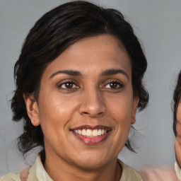 Joyful black adult female with medium  brown hair and brown eyes