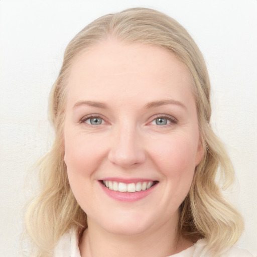 Joyful white young-adult female with long  blond hair and blue eyes