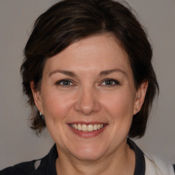 Joyful white adult female with medium  brown hair and brown eyes