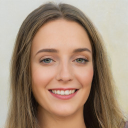 Joyful white young-adult female with long  brown hair and green eyes