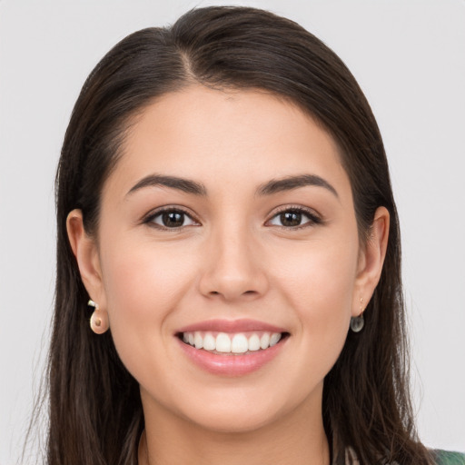 Joyful white young-adult female with long  brown hair and brown eyes