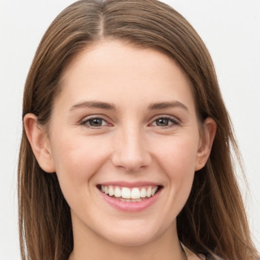 Joyful white young-adult female with long  brown hair and grey eyes