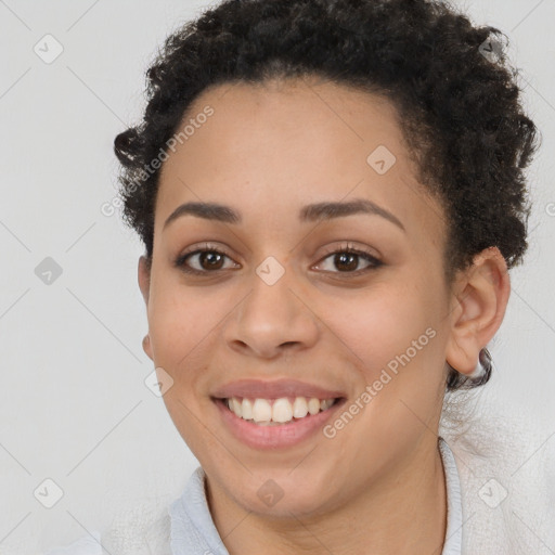 Joyful black young-adult female with short  brown hair and brown eyes