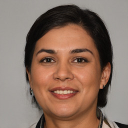 Joyful white adult female with medium  brown hair and brown eyes