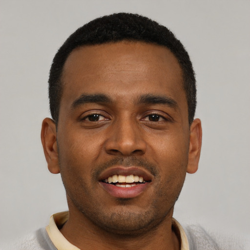 Joyful black young-adult male with short  black hair and brown eyes