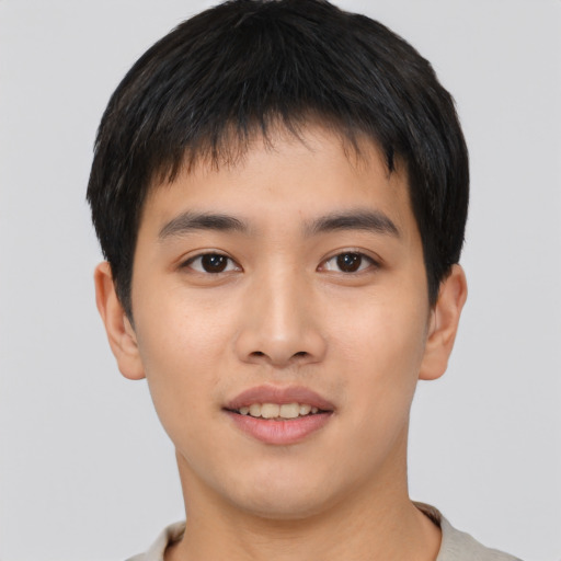 Joyful asian young-adult male with short  black hair and brown eyes
