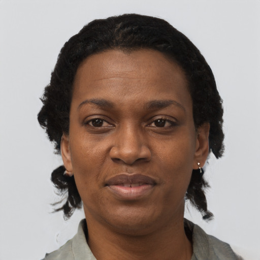Joyful black adult female with short  black hair and brown eyes