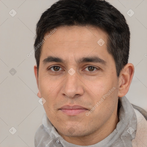 Joyful white adult male with short  brown hair and brown eyes