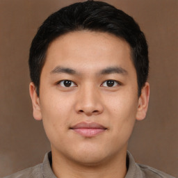 Joyful asian young-adult male with short  black hair and brown eyes