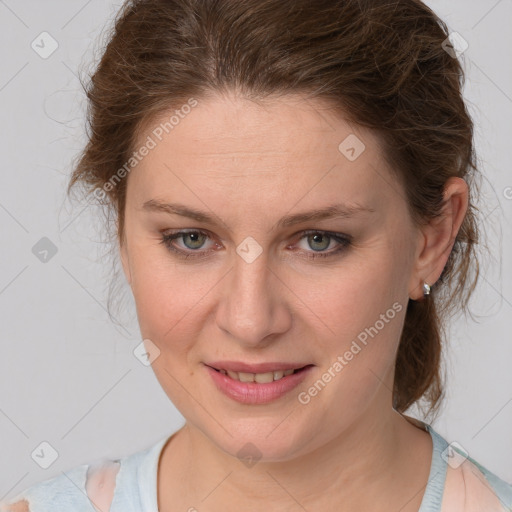 Joyful white young-adult female with medium  brown hair and blue eyes